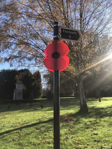 Remembrance poppy on footpath sign