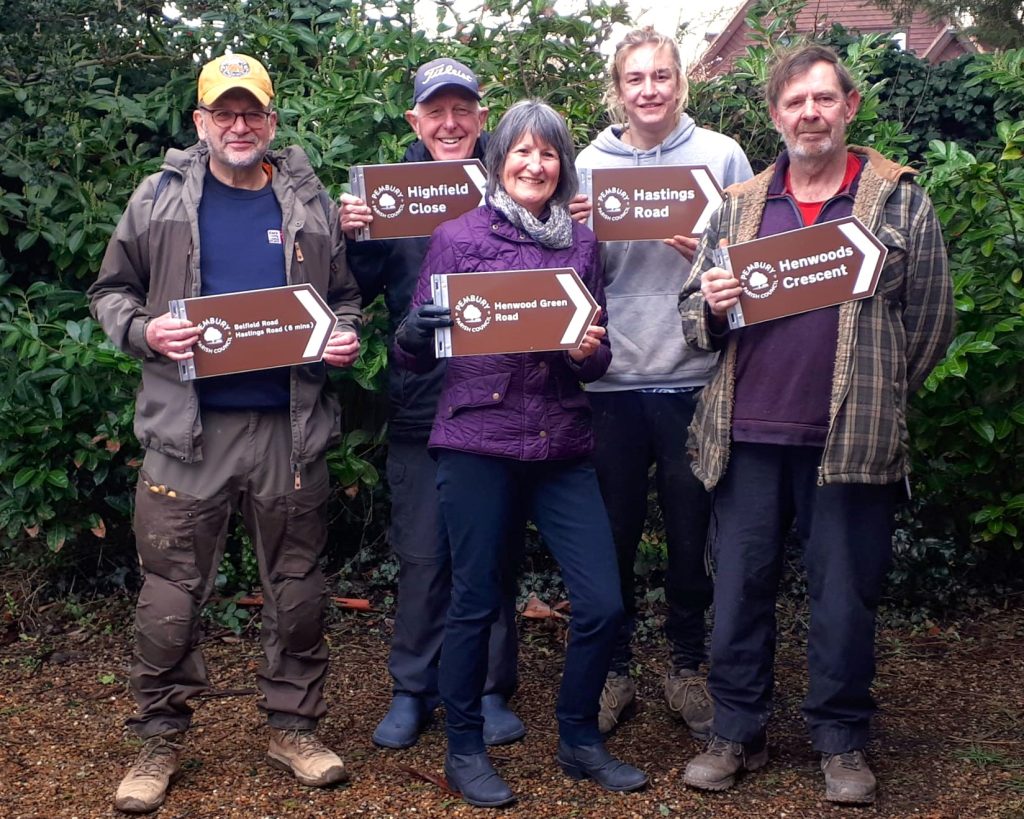 People holding new footpath signs